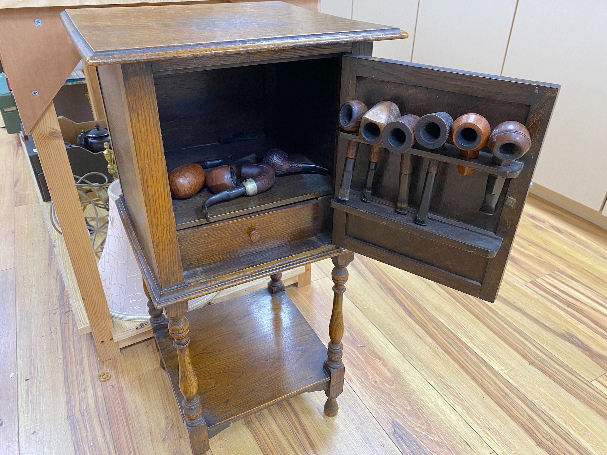 An oak smokers cabinet and pipes